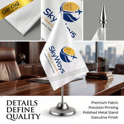A white table flag on a polished silver metal stand, printed with the 'Skyways Travel & Tour' logo. The image is a composite showing the flag in an office setting, close-up details of the fabric, and a gold gift box, with text highlighting premium fabric and precision printing.