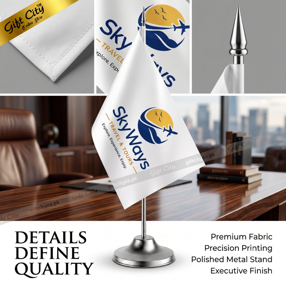 A white table flag on a polished silver metal stand, printed with the 'Skyways Travel & Tour' logo. The image is a composite showing the flag in an office setting, close-up details of the fabric, and a gold gift box, with text highlighting premium fabric and precision printing.