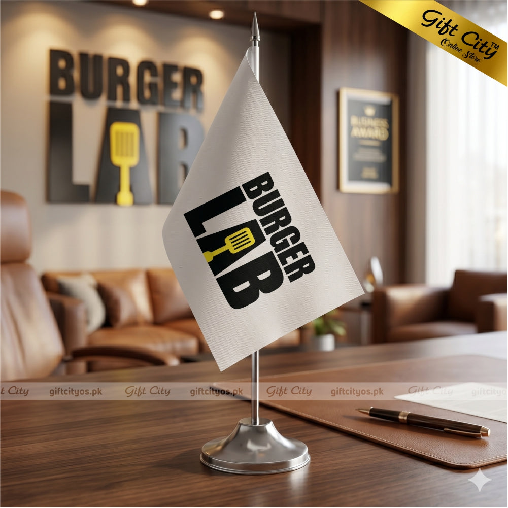 Tabletop flag with 'Burger Lab' design on a desk in a restaurant setting.