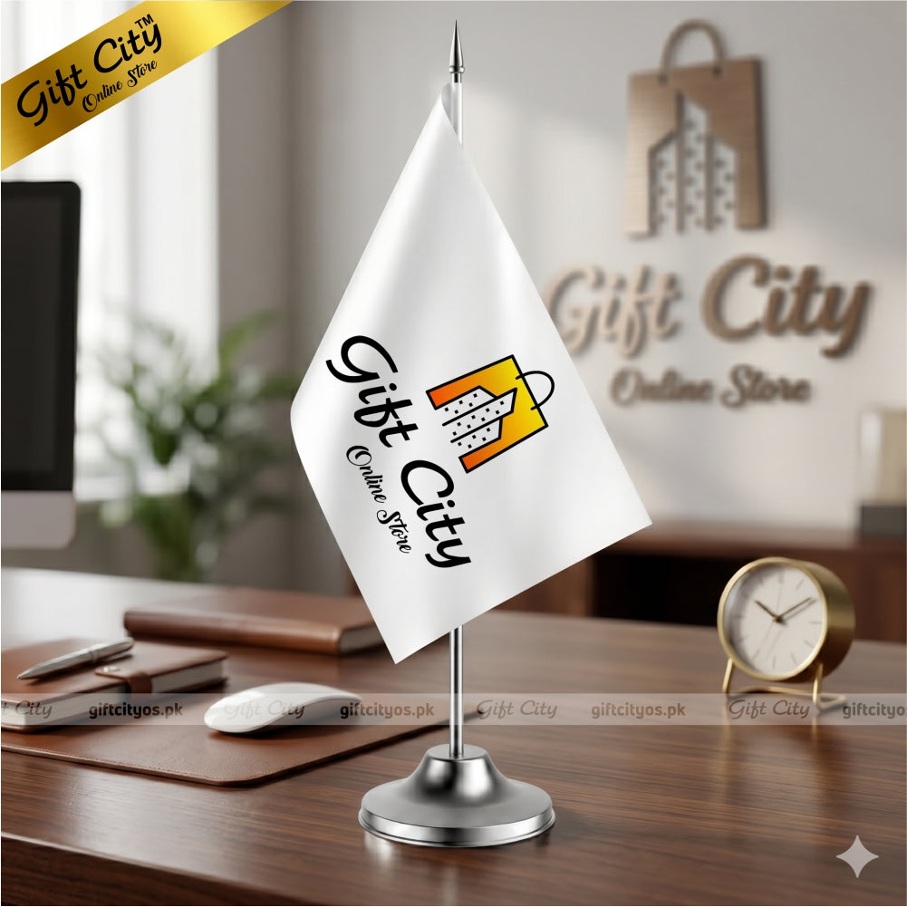 Desk with a white flag featuring 'Gift City Online Store' logo, office supplies, and a clock.
